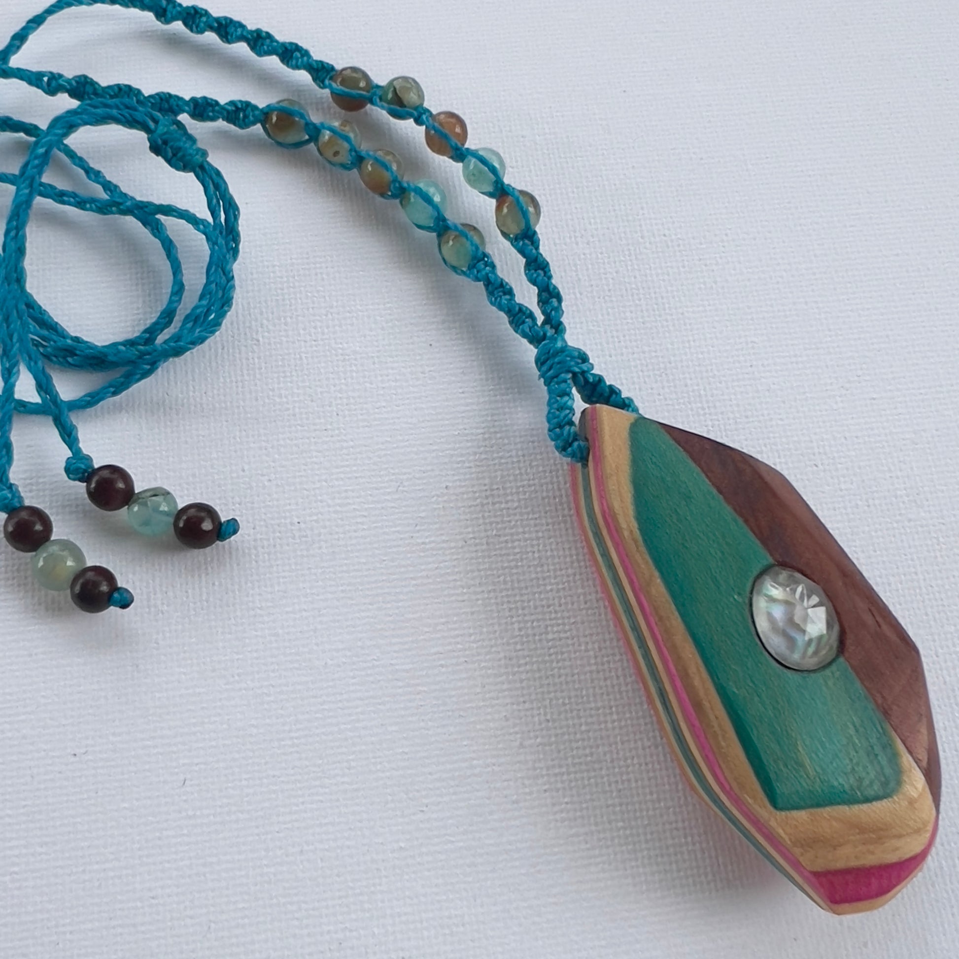 Handmade, unique recycled skateboard pendant with embedded Paua Shell & Quartz Doublet on an adjustable macrame necklace cord woven with Chalcedony beading