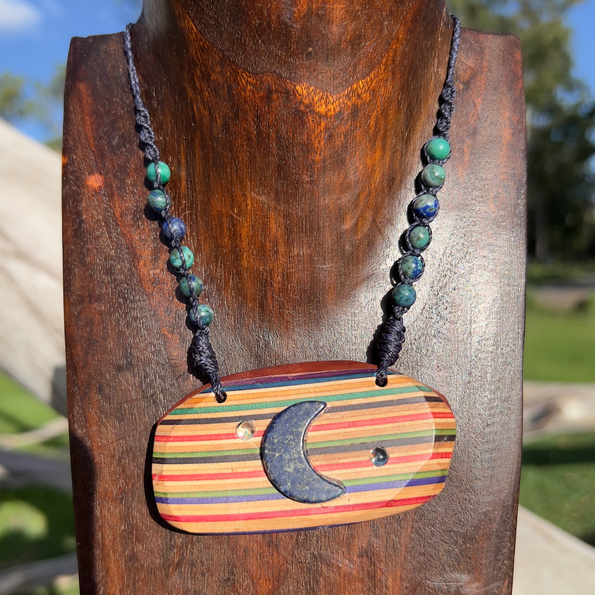 Handmade, unique recycled skateboard pendant with embedded Lapis Lazuli Moon and Topaz Stars on an adjustable macrame necklace cord woven with Azurite beading