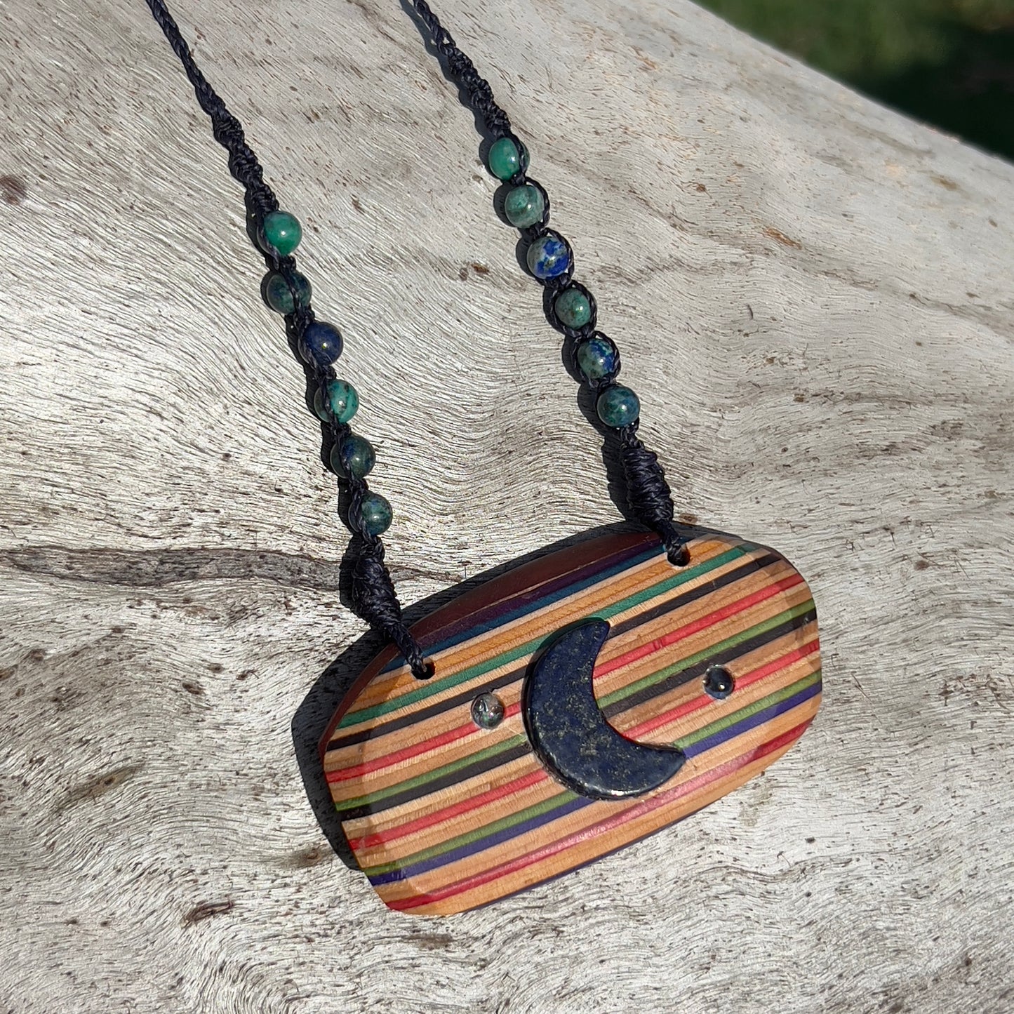 Handmade, unique recycled skateboard pendant with embedded Lapis Lazuli Moon and Topaz Stars on an adjustable macrame necklace cord woven with Azurite beading