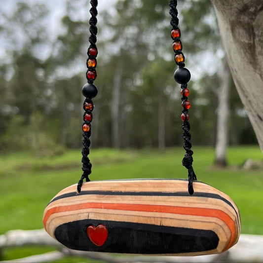 Handmade, unique recycled skateboard pendant with lush embedded Carnelian crystal heart on an adjustable macrame necklace cord woven with Obsidian and Carnelian.