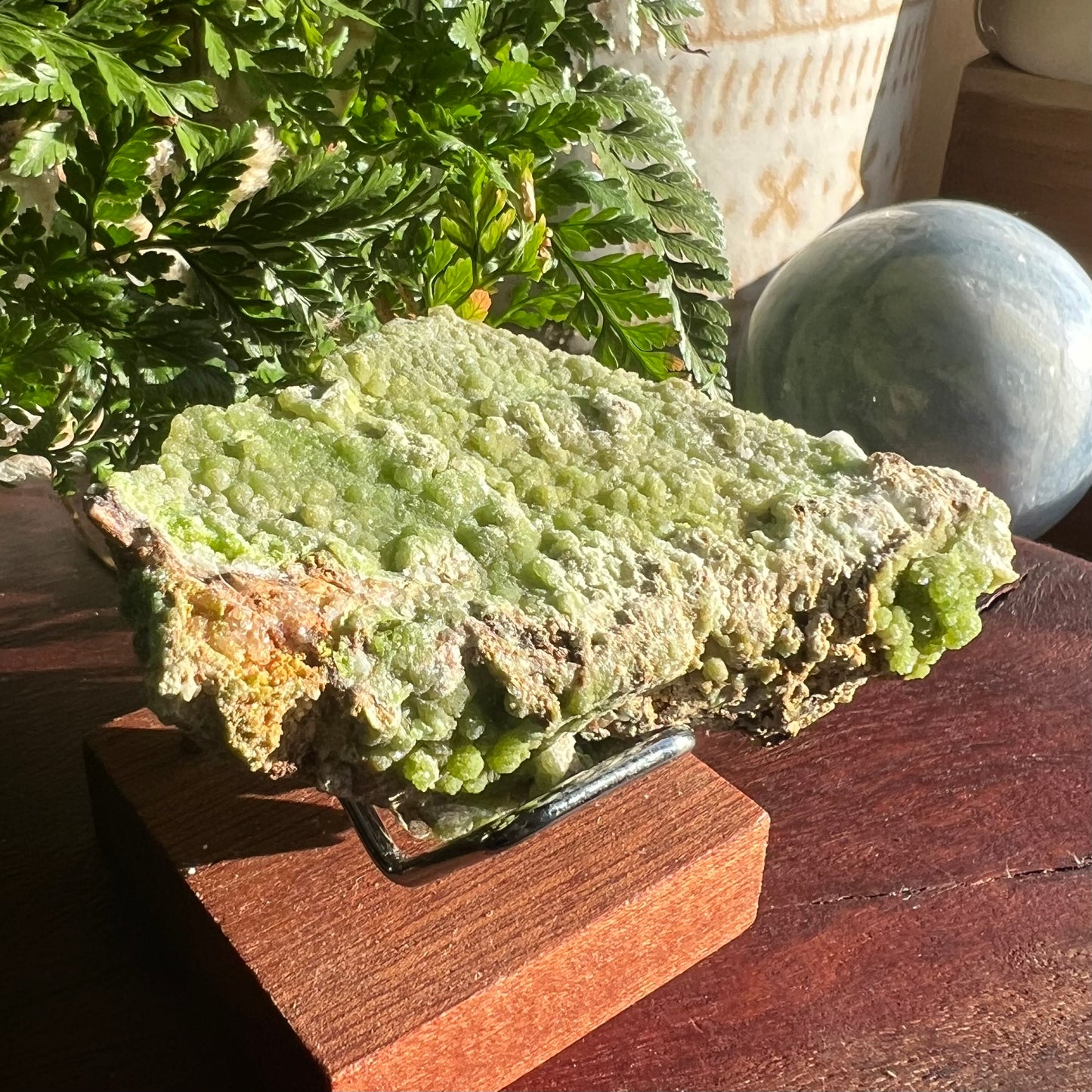 The apple green Pyromorphite specimen displayed in a stand for an example.