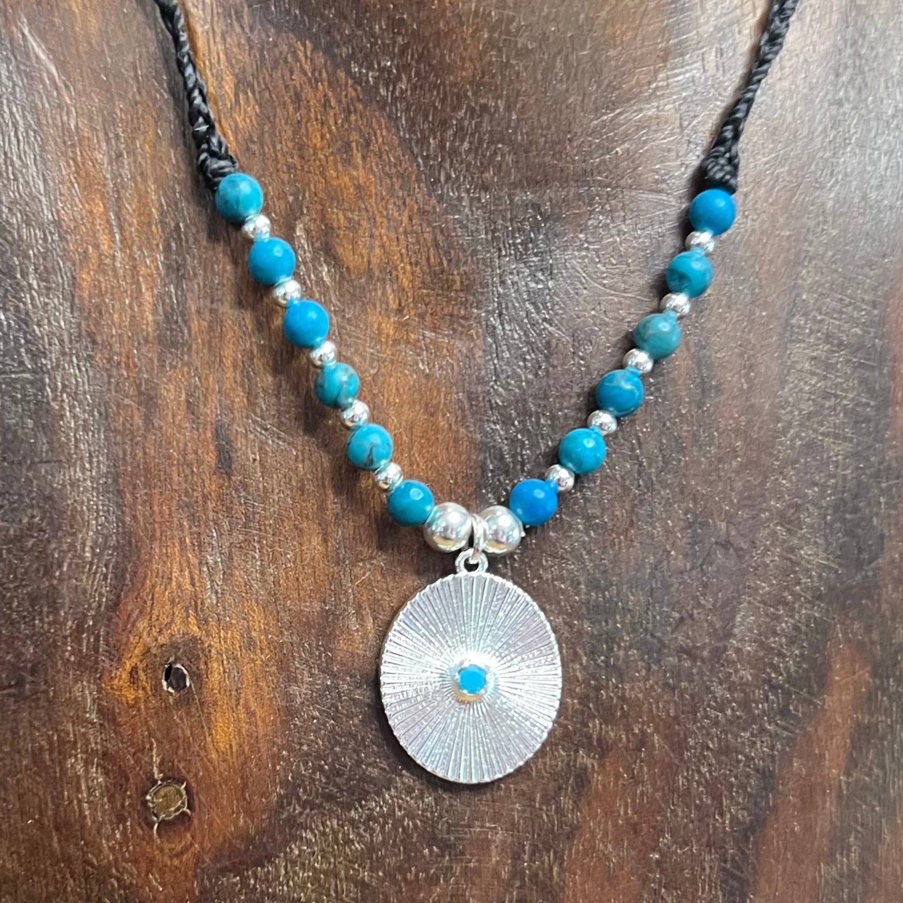 Handmade Adjustable Macrame Necklace with vibrant Sky Blue Spiderweb Jasper and Silver plated CZ pendant.