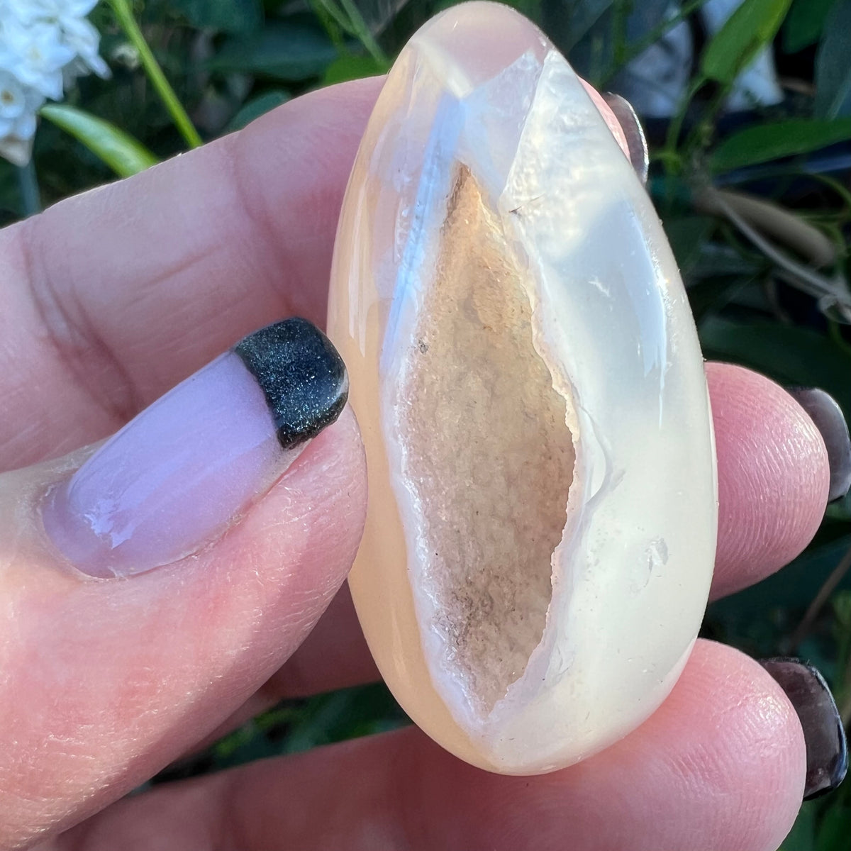 Sparkly druzy cavern inside polished agate tumblestone