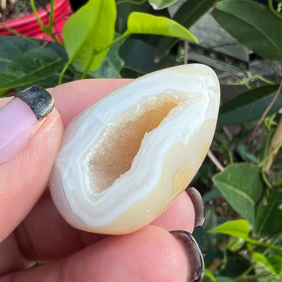 Sparkling crystalline interior cavity of a polished agate geode stone with natural mineral banding.